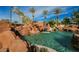 Custom pool with rock features, a waterfall, and clear blue water, creating a resort-like experience at 8280 Via Olivero Ave, Las Vegas, NV 89117