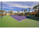 Well-maintained tennis court with a basketball hoop, professional lighting, and manicured landscaping at 8280 Via Olivero Ave, Las Vegas, NV 89117