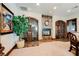 An entertaining area includes a wine cellar, fireplace, and classic wall art at 8280 Via Olivero Ave, Las Vegas, NV 89117