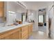 Double vanity bathroom with tiled floors showcases bathtub with shower features at 8426 Sluman Ct, Las Vegas, NV 89128