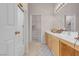 Bright bathroom featuring a double vanity, walk-in closet, and a glass-enclosed shower at 8426 Sluman Ct, Las Vegas, NV 89128