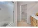 Bright bathroom featuring a glass shower door, light wood cabinets and walk-in closet with shelving at 8426 Sluman Ct, Las Vegas, NV 89128