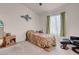 Cozy bedroom featuring a comfortable bed, ceiling fan, and a window at 8426 Sluman Ct, Las Vegas, NV 89128