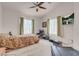 Spacious bedroom featuring a ceiling fan, television and green curtains at 8426 Sluman Ct, Las Vegas, NV 89128