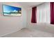 Bedroom featuring a TV, neutral colored walls, and a window with curtains at 8426 Sluman Ct, Las Vegas, NV 89128