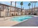 Community pool surrounded by palm trees and apartment buildings at 8426 Sluman Ct, Las Vegas, NV 89128