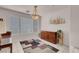 Inviting dining room featuring neutral decor, a large window, and stylish chandelier lighting at 8426 Sluman Ct, Las Vegas, NV 89128