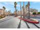 Wide shot of community entrance with palm trees and well-maintained landscaping at 8426 Sluman Ct, Las Vegas, NV 89128