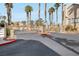 Community entrance featuring gates and lush desert landscaping at 8426 Sluman Ct, Las Vegas, NV 89128