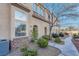 Beautifully landscaped townhouse with stone accents, mature bushes and a sidewalk entrance at 8426 Sluman Ct, Las Vegas, NV 89128