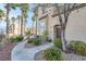 Inviting exterior view with desert landscaping and palm trees enhancing curb appeal at 8426 Sluman Ct, Las Vegas, NV 89128