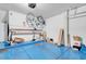 Garage with blue painted floor, storage shelves, bicycles, ladder and assorted storage containers at 8426 Sluman Ct, Las Vegas, NV 89128