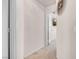 Hallway with neutral carpet leading to a doorway with a view of a living space at 8426 Sluman Ct, Las Vegas, NV 89128