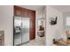 Modern kitchen with stainless steel refrigerator, wood cabinetry, and tiled floors at 8426 Sluman Ct, Las Vegas, NV 89128