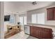 Well-lit kitchen featuring wooden cabinets, granite countertops, and stainless steel appliances at 8426 Sluman Ct, Las Vegas, NV 89128