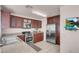 Open kitchen with stainless steel appliances, granite countertops, and dark wood cabinets at 8426 Sluman Ct, Las Vegas, NV 89128