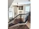 View of the landing with windows and railings overlooking the living area with a piano and staircase at 8426 Sluman Ct, Las Vegas, NV 89128