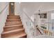 Staircase with hardwood steps leading to a naturally lit open living space at 8426 Sluman Ct, Las Vegas, NV 89128