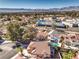 Aerial view showcases a home with a pool, red tile roof, and neighborhood setting with mountain views at 8932 Beach Front Dr, Las Vegas, NV 89117