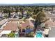 Aerial view features a home with a red tile roof, swimming pool, well-manicured landscaping, and neighborhood setting at 8932 Beach Front Dr, Las Vegas, NV 89117