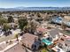 Aerial view shows a well-maintained neighborhood, with a home, mature landscaping, and a backyard pool at 8932 Beach Front Dr, Las Vegas, NV 89117