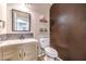 Cozy powder room featuring modern fixtures, light wood vanity, and a decorative accent wall for added charm at 8932 Beach Front Dr, Las Vegas, NV 89117