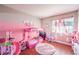 Charming bedroom painted in pink hues, offering plenty of room to play and relax at 8932 Beach Front Dr, Las Vegas, NV 89117