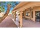 Covered patio features a ceiling fan, stone flooring, and stucco columns, extending to a low-maintenance rock garden at 8932 Beach Front Dr, Las Vegas, NV 89117