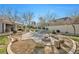 Inviting backyard with a brick patio, fire pit, and lush landscaping, perfect for relaxing or entertaining at 9435 Westwind Rd, Las Vegas, NV 89139