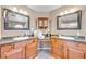 Elegant bathroom featuring dual sinks, granite counters, and classic wood cabinetry at 9435 Westwind Rd, Las Vegas, NV 89139