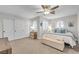 A bright, airy bedroom that features white trim, a ceiling fan, and large closets at 9435 Westwind Rd, Las Vegas, NV 89139