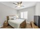 This bedroom features a ceiling fan, light-colored walls, and a window with white shutters at 9435 Westwind Rd, Las Vegas, NV 89139