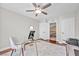 Bright bedroom featuring a ceiling fan, a glass desk and access to the hallway at 9435 Westwind Rd, Las Vegas, NV 89139