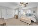 Bright bedroom with multiple windows, closet doors, and a cozy bed at 9435 Westwind Rd, Las Vegas, NV 89139