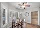 Dining area with plantation shutters, table with seating, and modern ceiling fan at 9435 Westwind Rd, Las Vegas, NV 89139