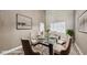 Staged dining room featuring a modern glass table and seating for six guests at 9435 Westwind Rd, Las Vegas, NV 89139