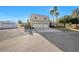 Exterior view of a two-story home with a spacious driveway and three-car garage at 9435 Westwind Rd, Las Vegas, NV 89139