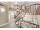 Elegant foyer with staircase, decorative table and wrought iron accents creates a welcoming entrance at 9435 Westwind Rd, Las Vegas, NV 89139