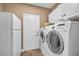 A laundry room with a side-by-side washer and dryer and plenty of storage space at 9435 Westwind Rd, Las Vegas, NV 89139