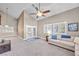 Open living room with vaulted ceilings, neutral carpet, and French doors to the outside at 9435 Westwind Rd, Las Vegas, NV 89139