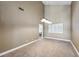Bright living room with high ceilings, carpet flooring, and large windows offers a welcoming space at 9435 Westwind Rd, Las Vegas, NV 89139