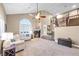 Bright living room with vaulted ceiling, large window, and staircase to second floor at 9435 Westwind Rd, Las Vegas, NV 89139