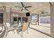 Covered patio features ceiling fans and outdoor TV next to a dining space at 9435 Westwind Rd, Las Vegas, NV 89139
