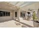 Expansive covered patio with stone fire pit, outdoor seating, ceiling fans, and ample room for entertaining at 9435 Westwind Rd, Las Vegas, NV 89139