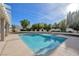 Inviting backyard features a sparkling pool, lush landscaping, and covered patio at 9435 Westwind Rd, Las Vegas, NV 89139