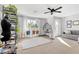 Stylish bonus room featuring a hanging chair, seating, and plenty of natural light at 10415 Scarpa St, Las Vegas, NV 89178