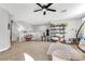 A comfortable bonus room featuring a hanging chair, seating area, and stairway access at 10415 Scarpa St, Las Vegas, NV 89178