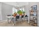 Bright dining area with a white table, modern chairs, and plenty of natural light at 10415 Scarpa St, Las Vegas, NV 89178