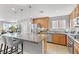 Open kitchen featuring stainless steel appliances, granite countertops, and a large island with bar seating at 10415 Scarpa St, Las Vegas, NV 89178