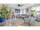 Bright living room with a comfortable gray sectional, stylish decor, and lush indoor plants at 10415 Scarpa St, Las Vegas, NV 89178